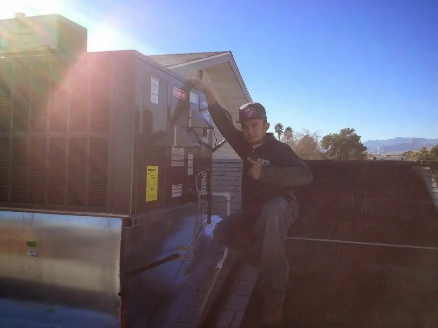 HVAC technician performing Air Duct Repair on a rooftop unit in Springettsbury